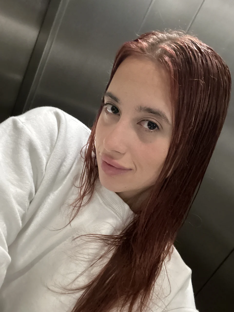 Natalye in a cream sweater with red hair